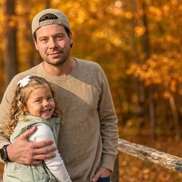 Jeremy DeRoy outdoors with a young child
